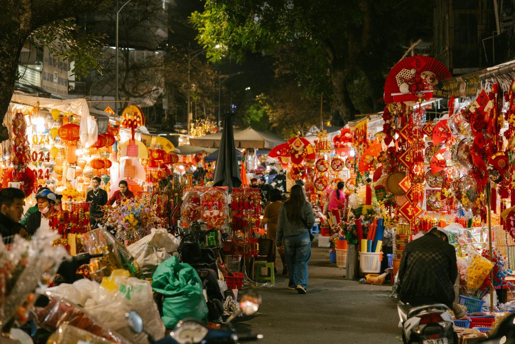 Home A bustling night market filled with colorful lanterns and festive decorations.